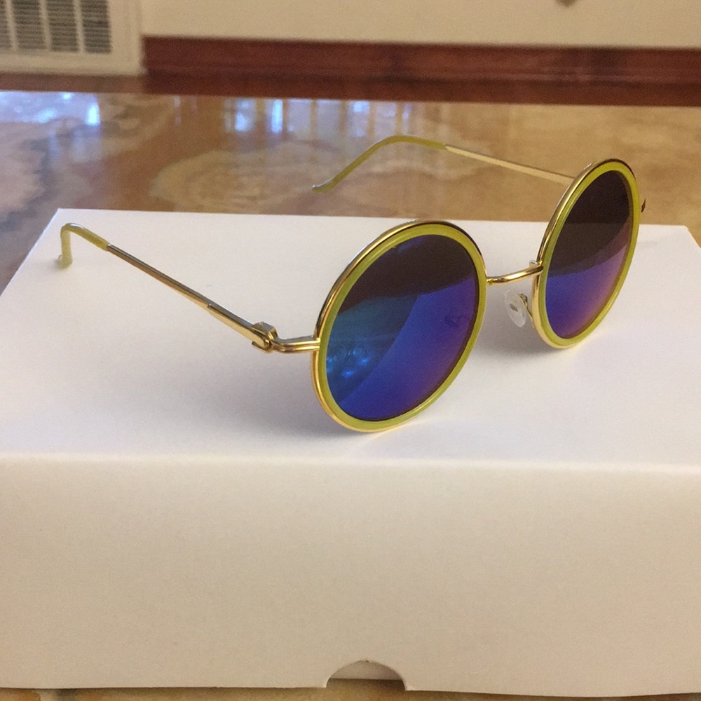 Gold framed sunglasses with round blue lenses